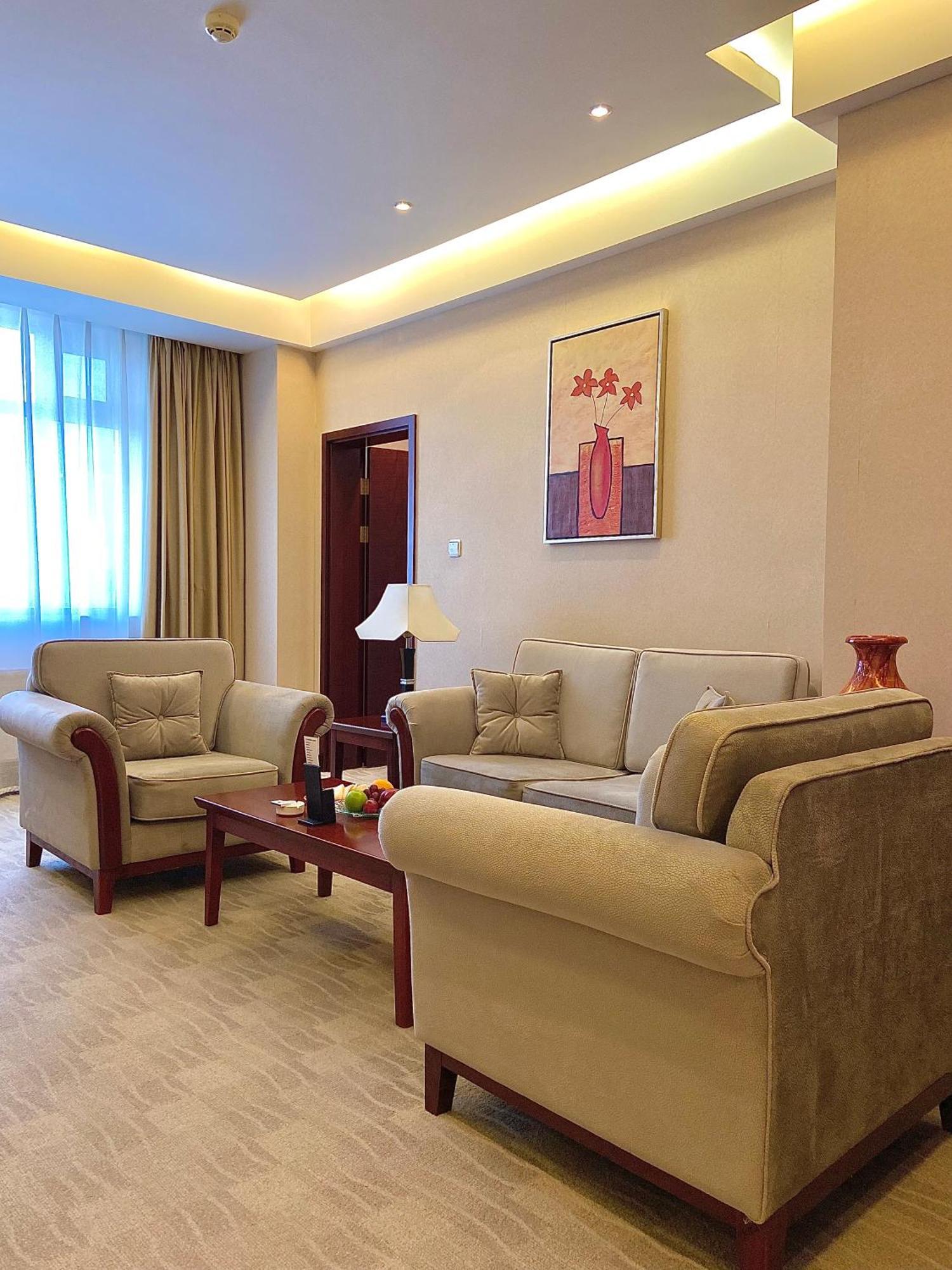 Beijing Palace Soluxe Hotel Astana Exterior foto A living room in a suite at the hotel